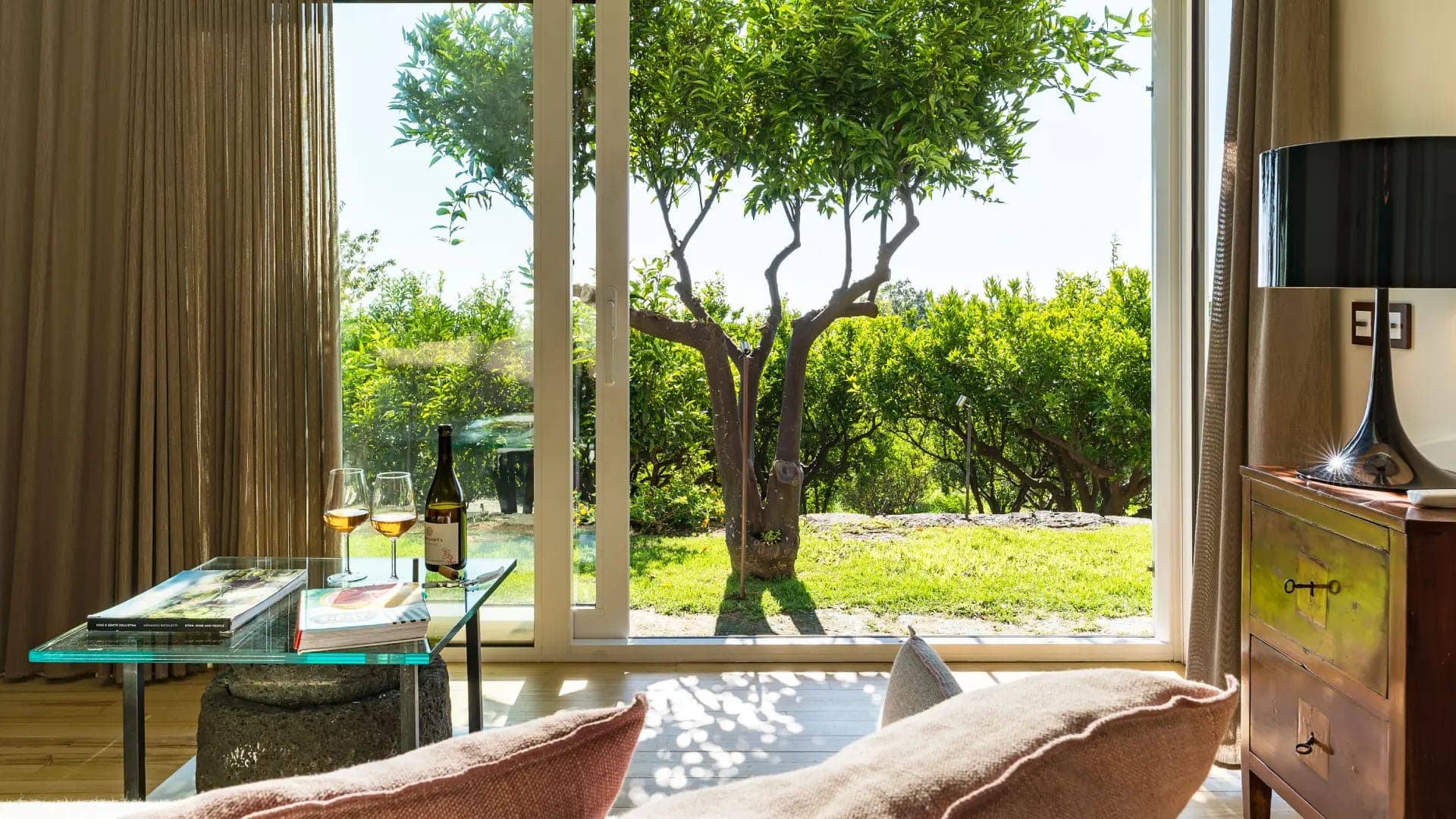A signature suite at Monaci, restored stone walls and pale linen above a private terrace.