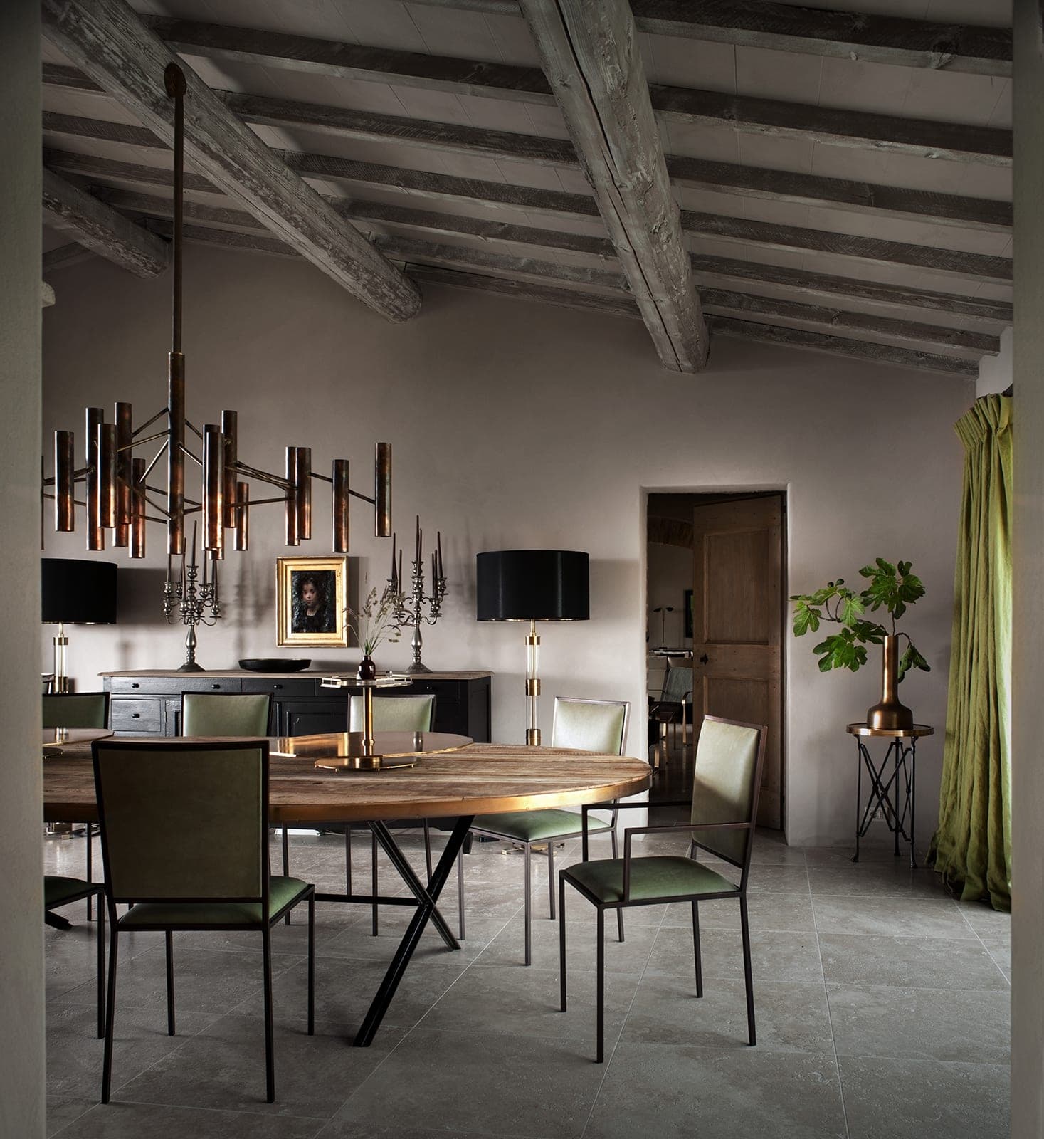 An interior detail of the castello, hand-made furniture and lamplight against tall stone walls.
